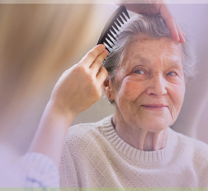 Aging Care Professional® combing senior adult hair